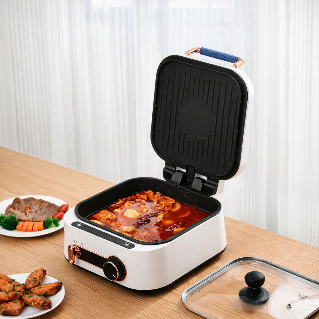 Multi-function electric grill and hot pot with non-stick cooking surface and adjustable temperature control.
