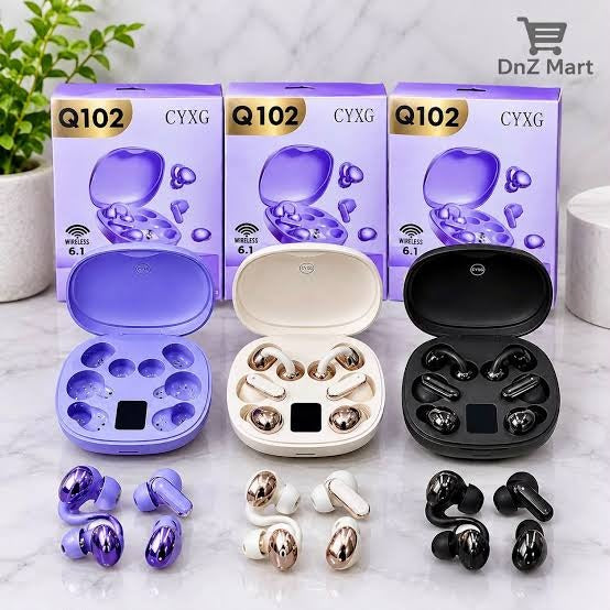 Three pairs of wireless earbuds with their charging cases displayed in front of their retail boxes. The set includes a purple pair, a champagne gold and white pair, and a black pair, all on a light marble surface with a green plant in the background.