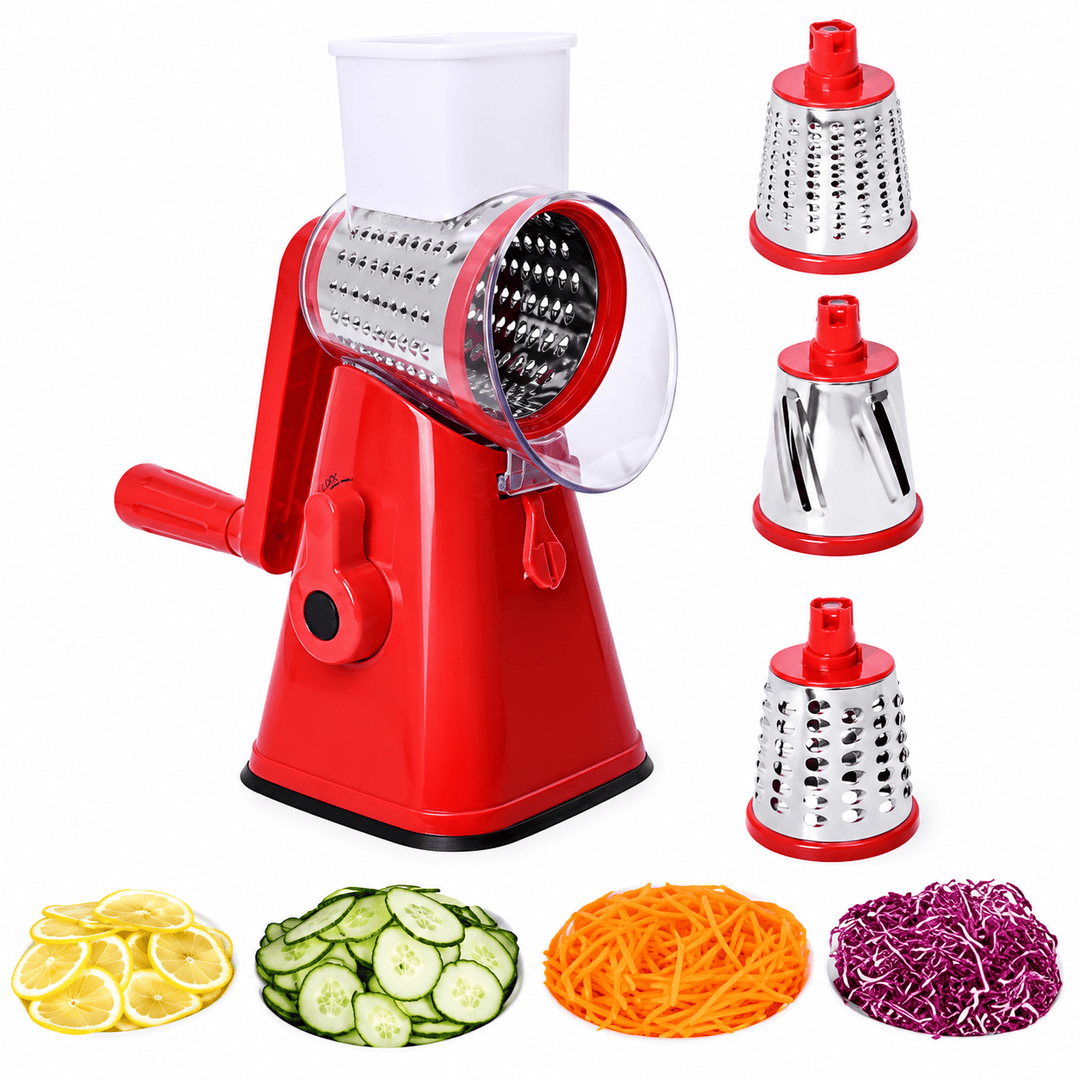 A red manual vegetable grater and slicer machine with a clear plastic hopper, shown on a white background with four interchangeable metal grating attachments on the right and sample food outputs including sliced cucumbers, shredded carrots, shredded purple cabbage, and lemon slices below.