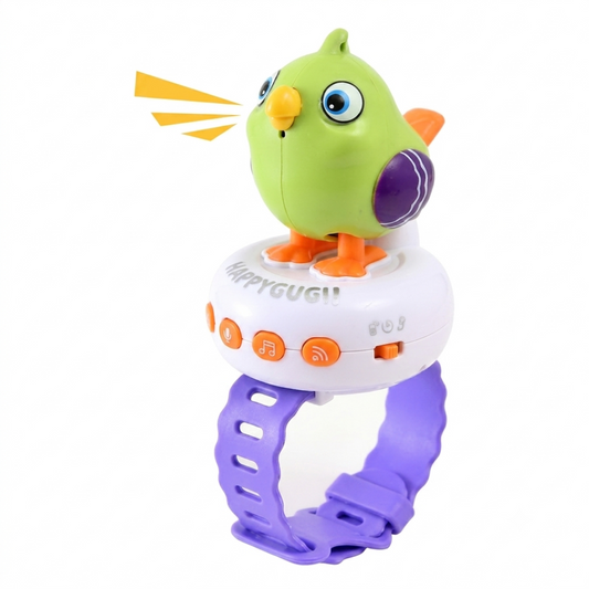 A colorful baby toy rattle shaped like a bird perched on a wristband. The toy features a bright green bird with orange beak and feet, a purple wing, and blue eyes, sitting on a white circular body with orange buttons and a purple elastic wrist strap.